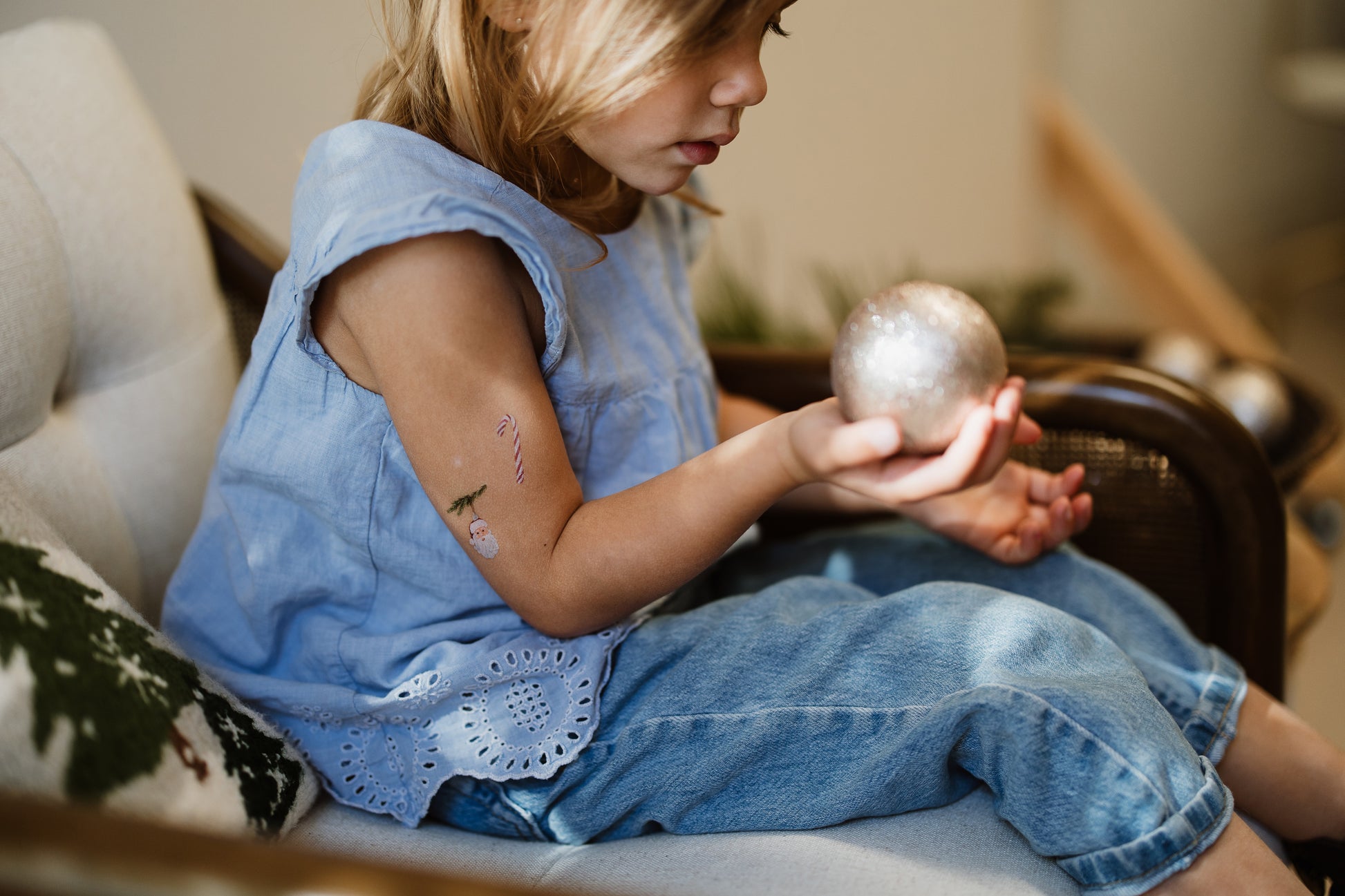 Child wearing Christmas temporary tattoos